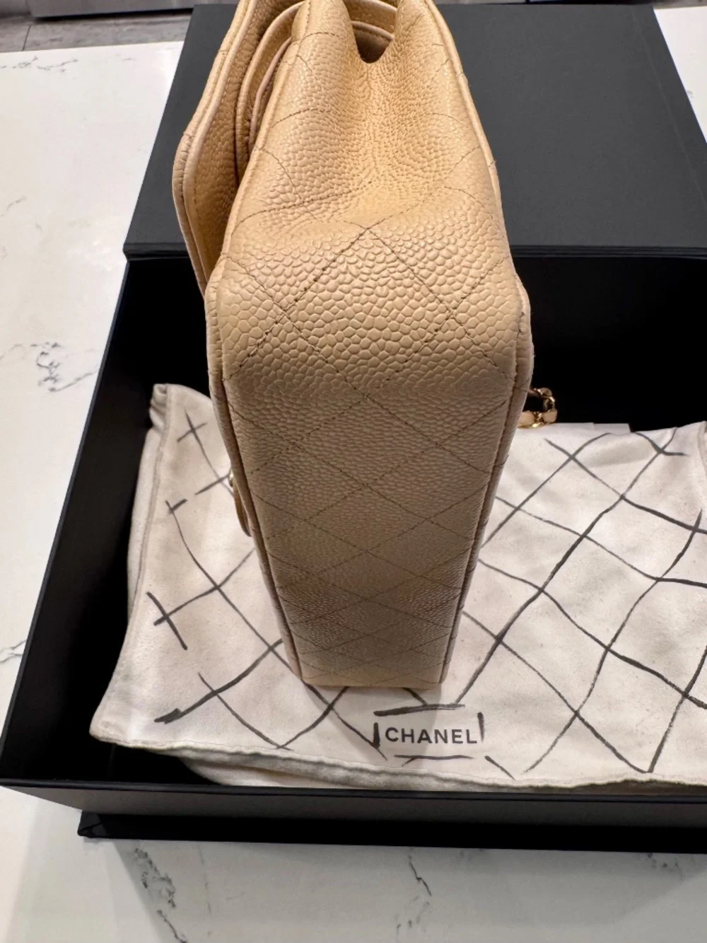 Chanel Classic Medium Double Flap in beige nude caviar with gold tone hardware.